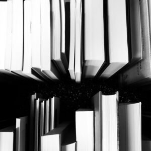 Artistic black and white photo of vertically arranged books viewed from above, showcasing a unique perspective.