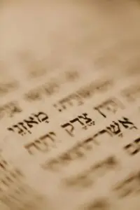 A detailed close-up of Hebrew text on a traditional religious document, emphasizing cultural significance.